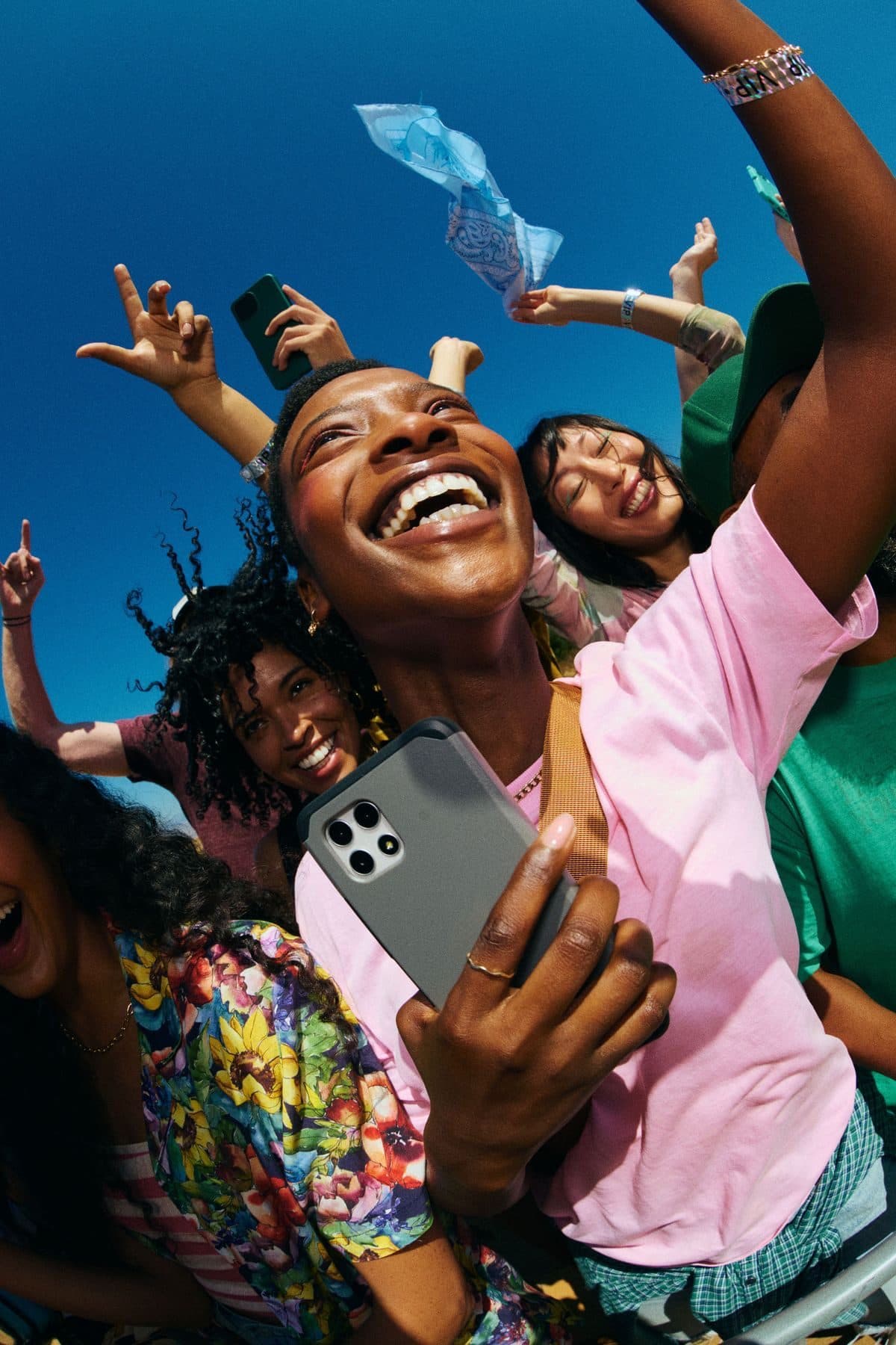 Friends capturing a moment together on a phone at an event